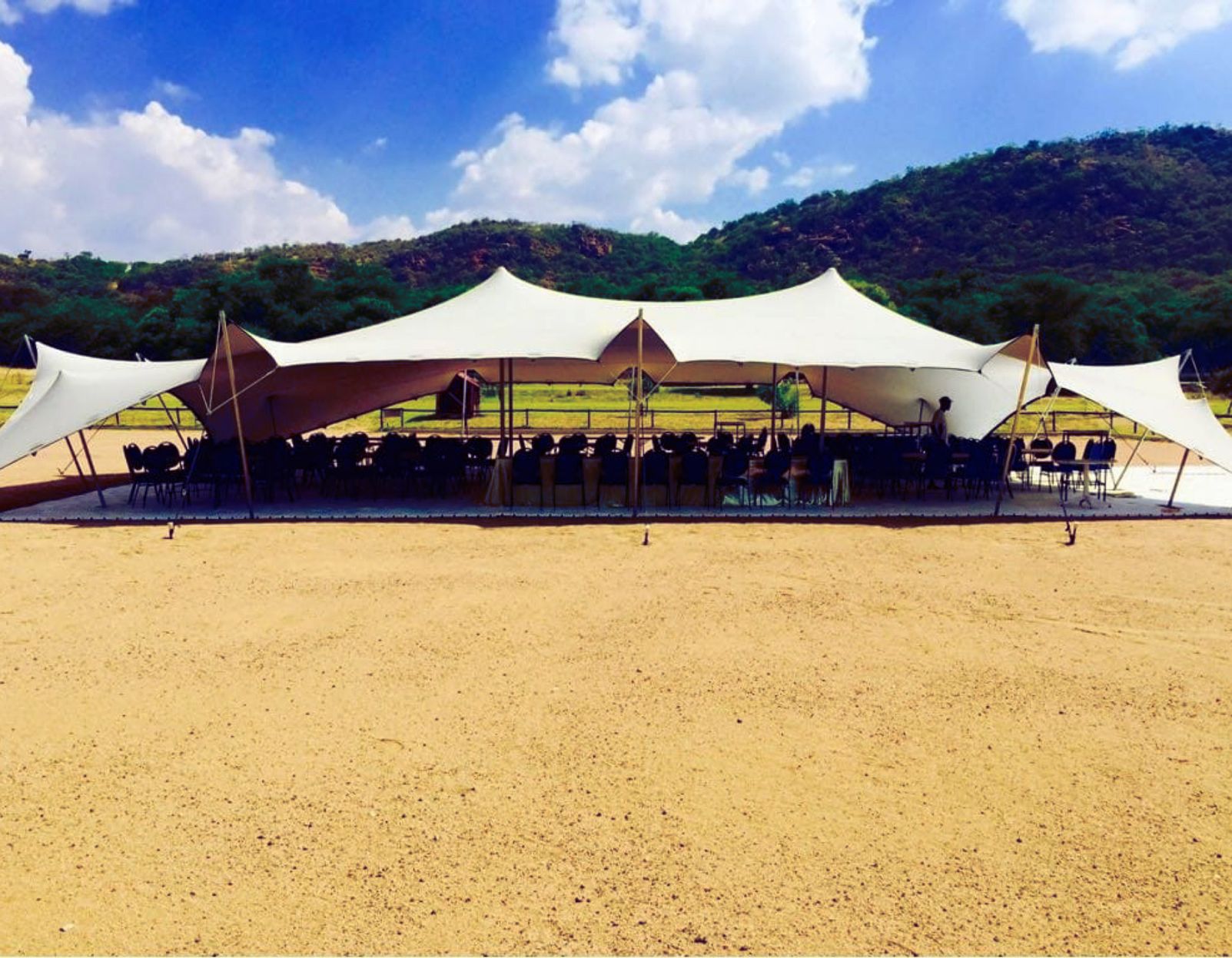 White Stretch Tent Used As Chapel For An Outdoor Wedding Ceremony.