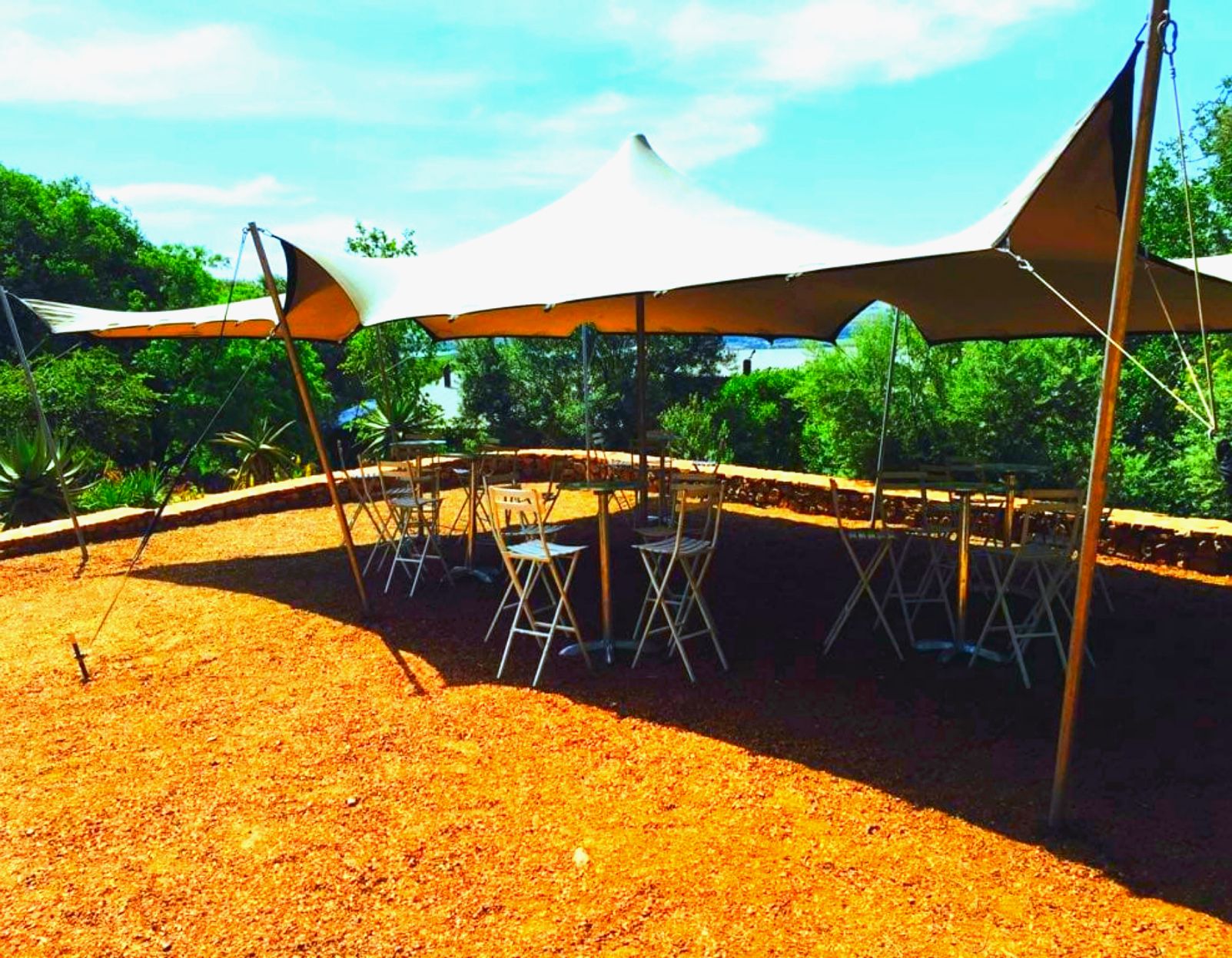 Stretch Tent With Bar Stools And Cocktail Tables on Sand.