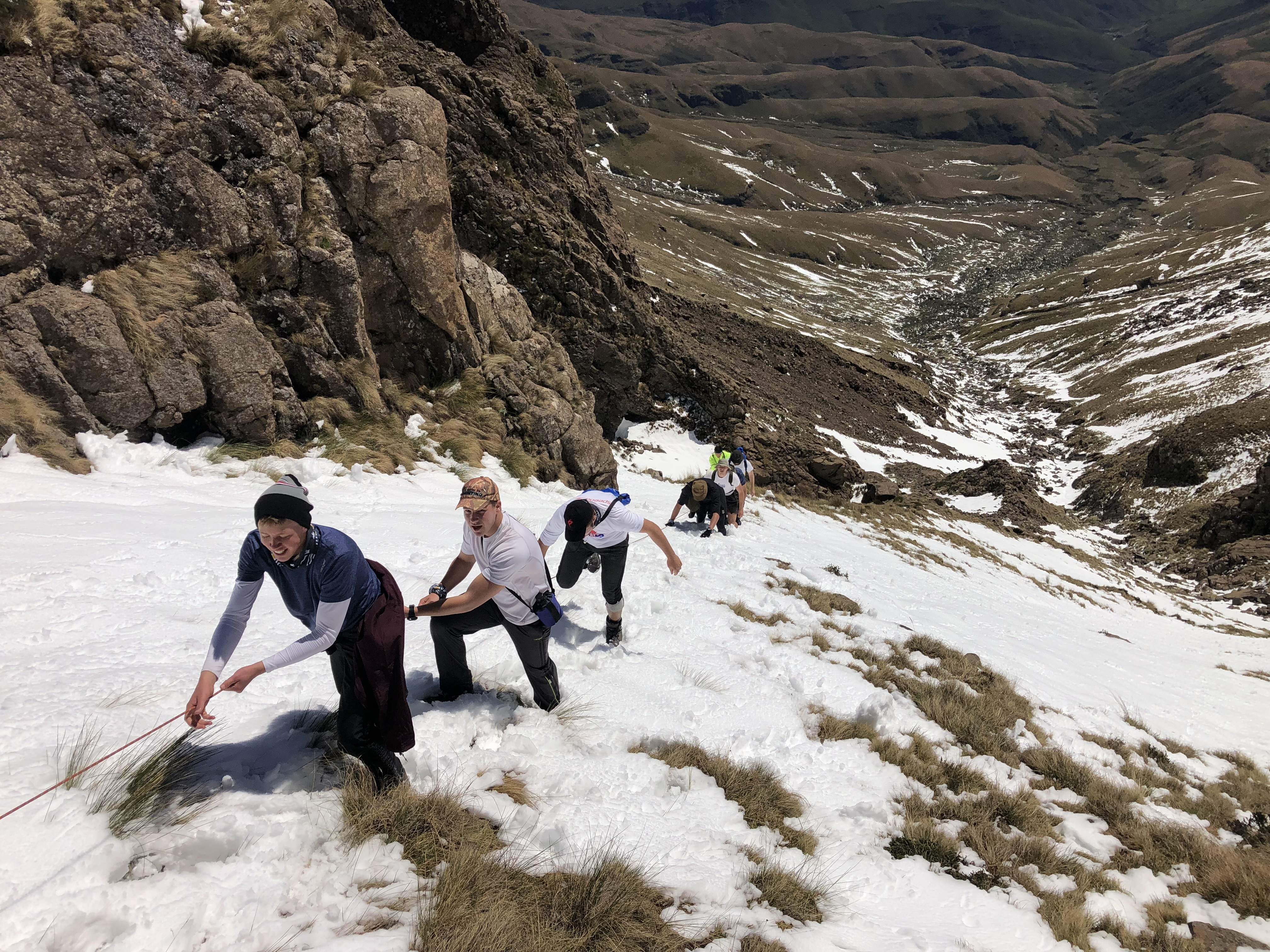 A group of boys climbing a mountain